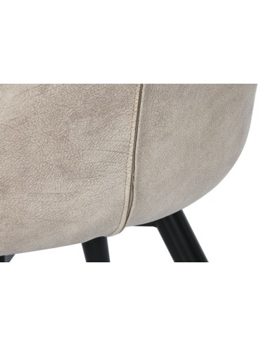 Silla de pu en beige con patas de metal.